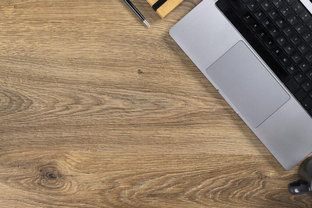 Minimalist workspace with laptop and notebook – symbolizing online business organization supported by an onlyfans manager